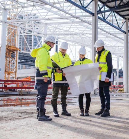 Engineers with blueprints and designs